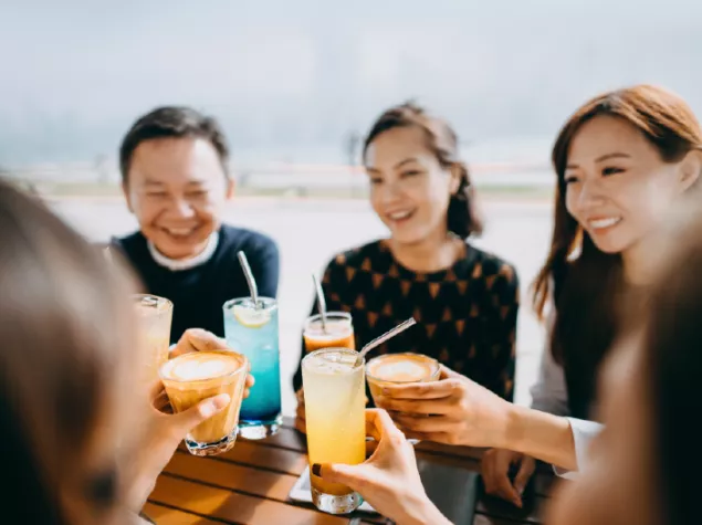 Friends with drinks at table
