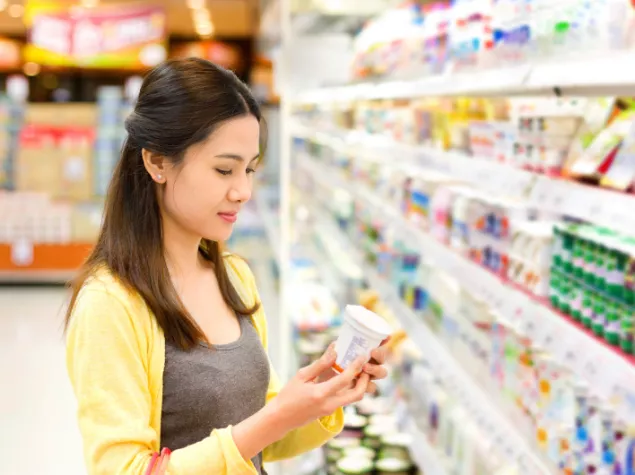 Lady holding yogurt pot