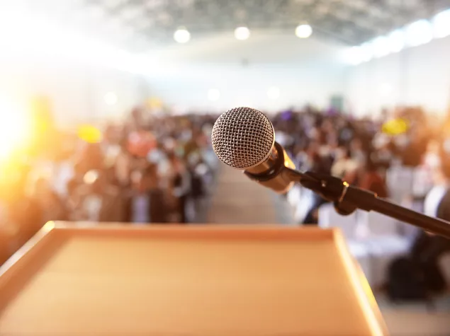 Microphone and blurred conference audience