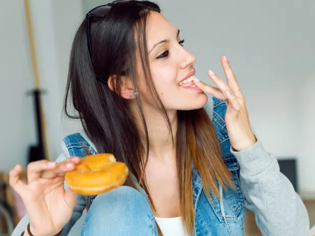 Woman eating doughnut