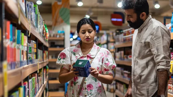 Woman reading food label on a box of sweets