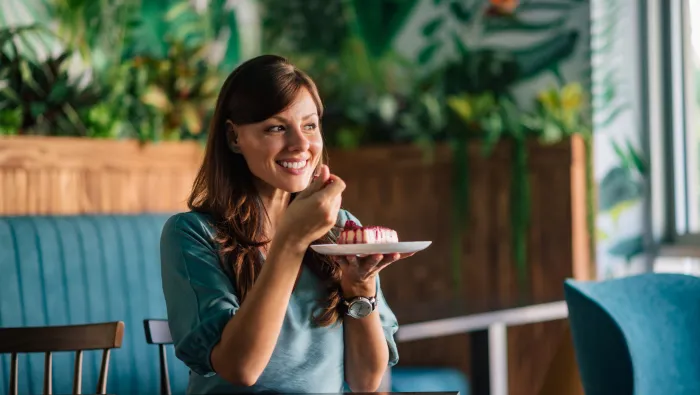 Lady eating cake with a fork