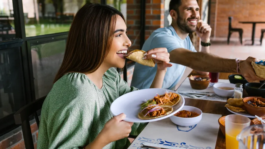 Lady eating tacos