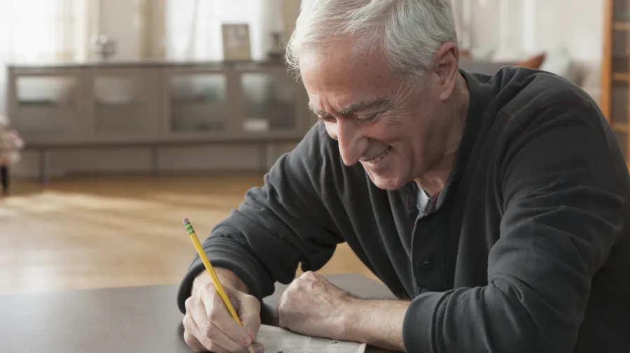 Older man doing a puzzle