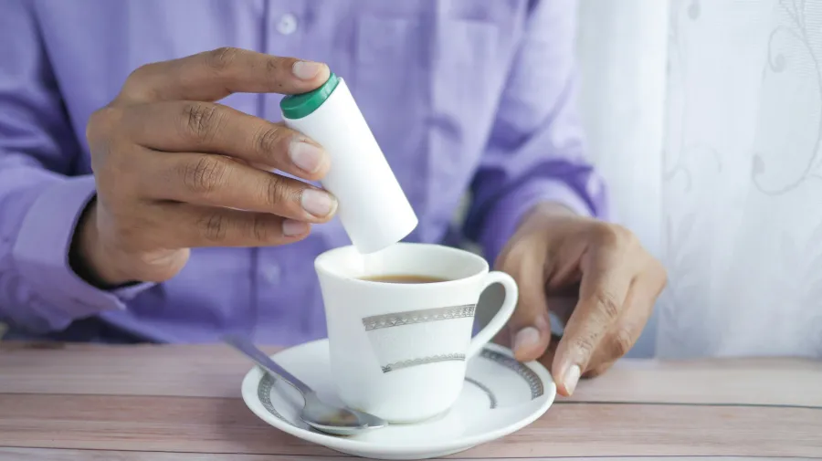 Image of someone using a sweetener